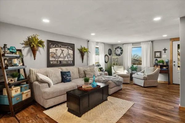 a living room with furniture and view of kitchen