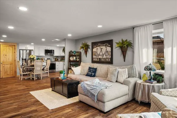 a kitchen with stainless steel appliances kitchen island granite countertop a stove refrigerator and a sink