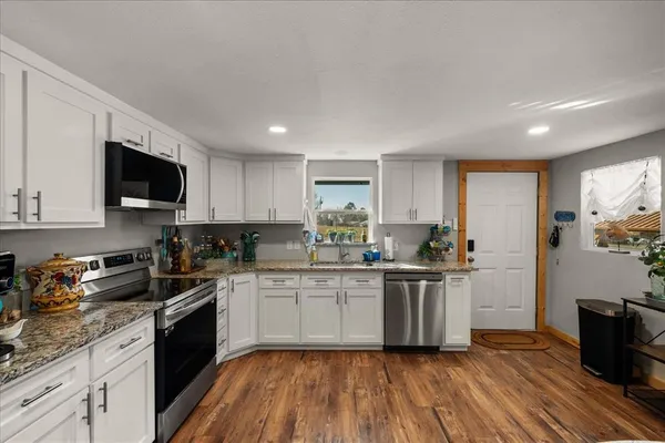 a view of a dining room with furniture and wooden floor