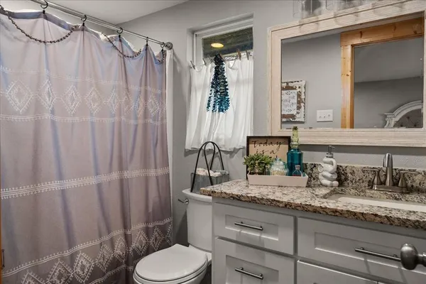 a bedroom with furniture and a flat screen tv