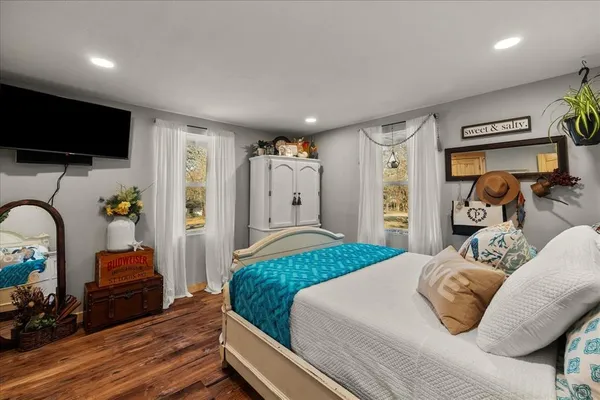 a bathroom with a granite countertop sink and a toilet