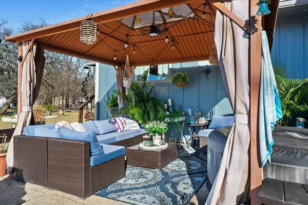 a view of a house with backyard water fountain and sitting area