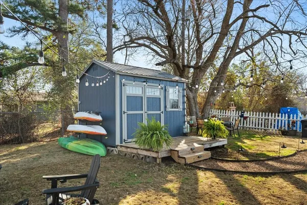 a view of a patio with table and chairs and potted plants
