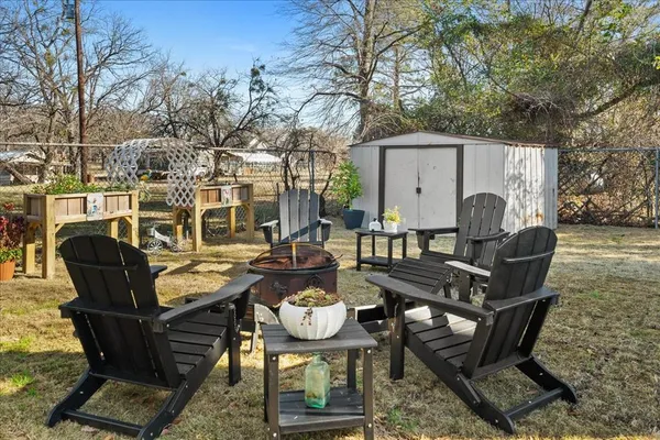 a view of a patio with table and chairs with wooden floor and fence
