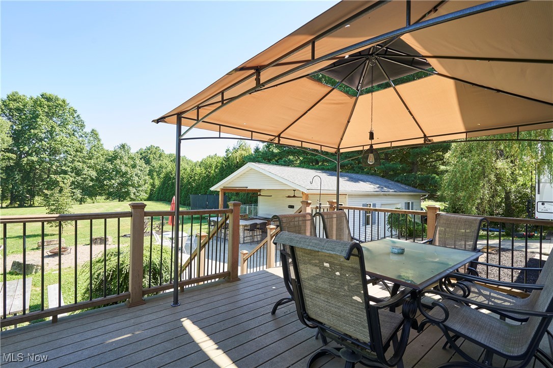 3741 Bassett Road Rootstown, OH 44272 - Photo 19 of 29 Wooden deck featuring outdoor dining area and an outbuilding