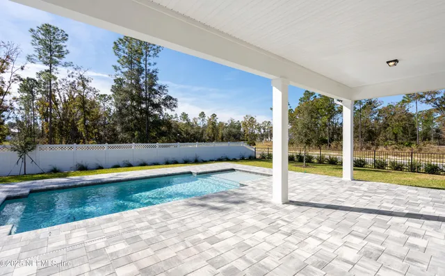 a large kitchen with stainless steel appliances granite countertop a lot of counter space and wooden floors