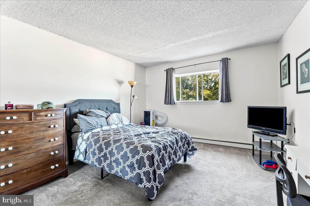 400 Glendale Road, Unit K52 Havertown, PA 19083 - Photo 13 of 17 a bedroom with a bed and a flat screen tv