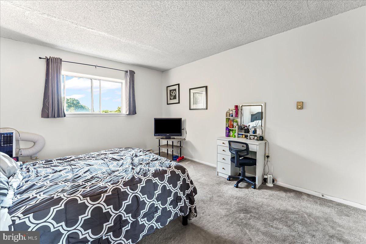 400 Glendale Road, Unit K52 Havertown, PA 19083 - Photo 14 of 17 a bedroom with a bed and a desk