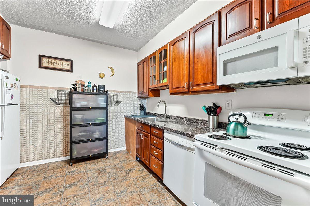 400 Glendale Road, Unit K52 Havertown, PA 19083 - Photo 9 of 17 a kitchen with stainless steel appliances granite countertop a sink and cabinets