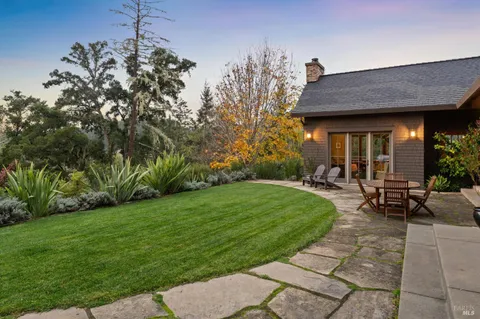 a view of a backyard with sitting area