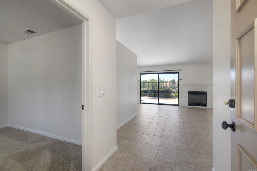 1394 Longfellow Road Vista, CA 92081 - Photo 6 of 50 a view of a hallway with an empty room and a window