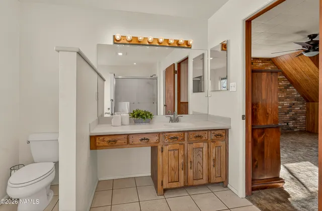 a spacious bathroom with a toilet a sink and mirror