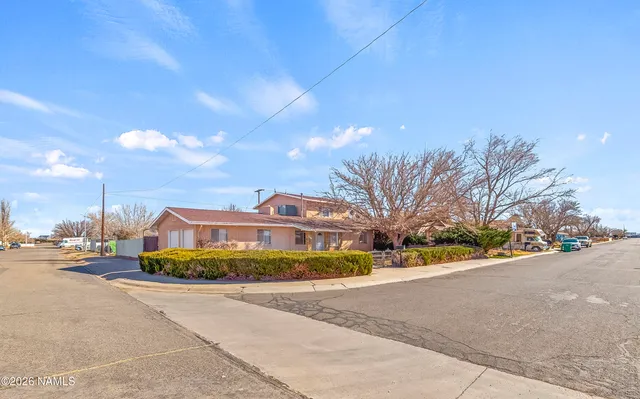 a view of a street with a cars parked on the road