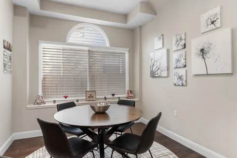 a kitchen with stainless steel appliances granite countertop a sink a stove a refrigerator and island with wooden floor