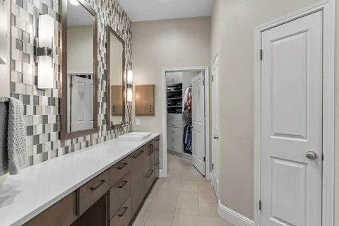 a bathroom with a double vanity sink and a mirror