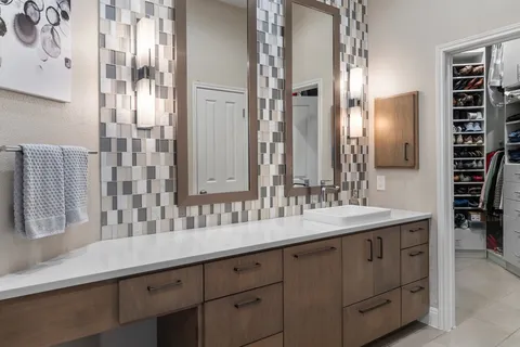 a spacious bathroom with a sink double vanity and a mirror