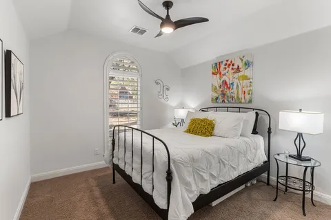 a bedroom with a bed and lamps