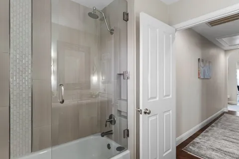 a bathroom with a bathtub and shower