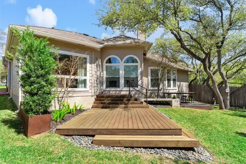 a front view of a house with a yard table and chairs