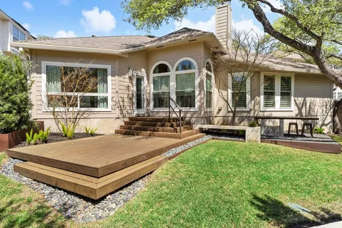 a view of a house with backyard porch and sitting area