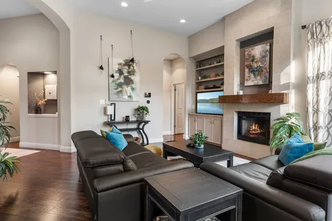 a living room with furniture potted plant and a large window