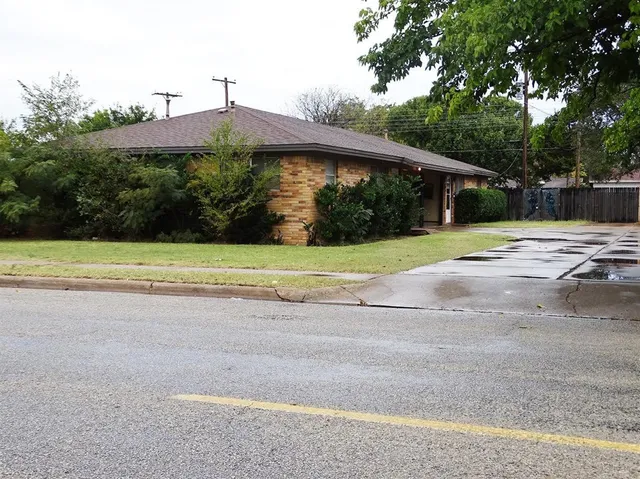 a view of a house with a yard and tree s