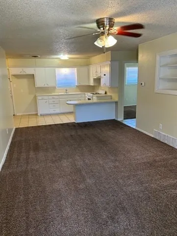 a view of kitchen with granite countertop cabinets and outdoor view
