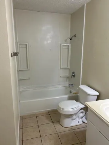 a bathroom with a toilet a sink and bathtub