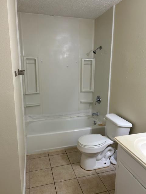 1636 58th Street, Unit B Lubbock, TX 79412 - Photo 6 of 8 a bathroom with a toilet a sink and bathtub