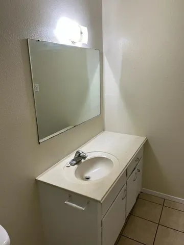 a bathroom with a sink and mirror