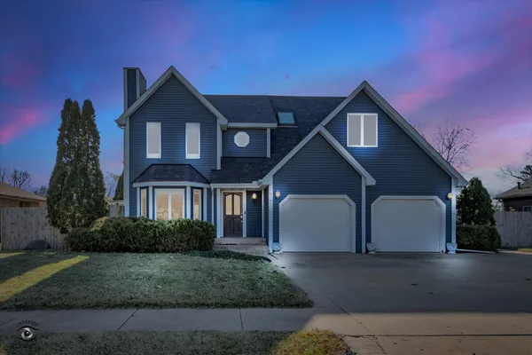 a front view of a house with a yard and garage