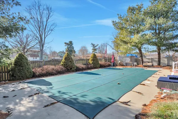 a view of a swimming pool and lounge chairs
