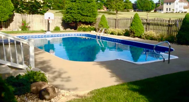 a view of a patio with table and chairs with wooden floor and fence