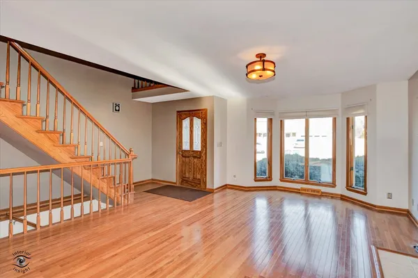 a view of an entryway with wooden floor