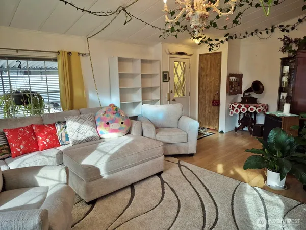 a living room with patio furniture and a potted plant