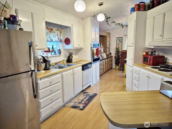 a kitchen with refrigerator and cabinets