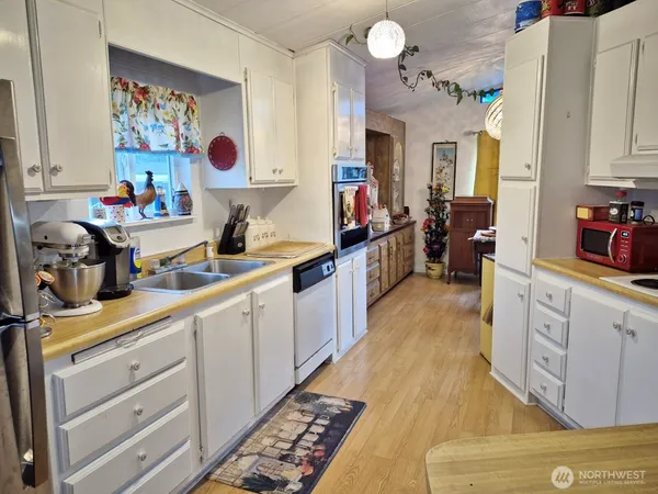 a kitchen with cabinets a sink and appliances