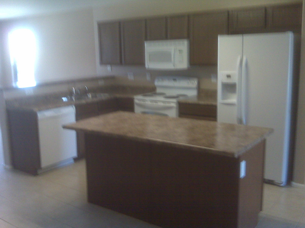 4617 West Carson Road Laveen, AZ 85339 - Photo 5 of 5 a kitchen with granite countertop a refrigerator and a sink