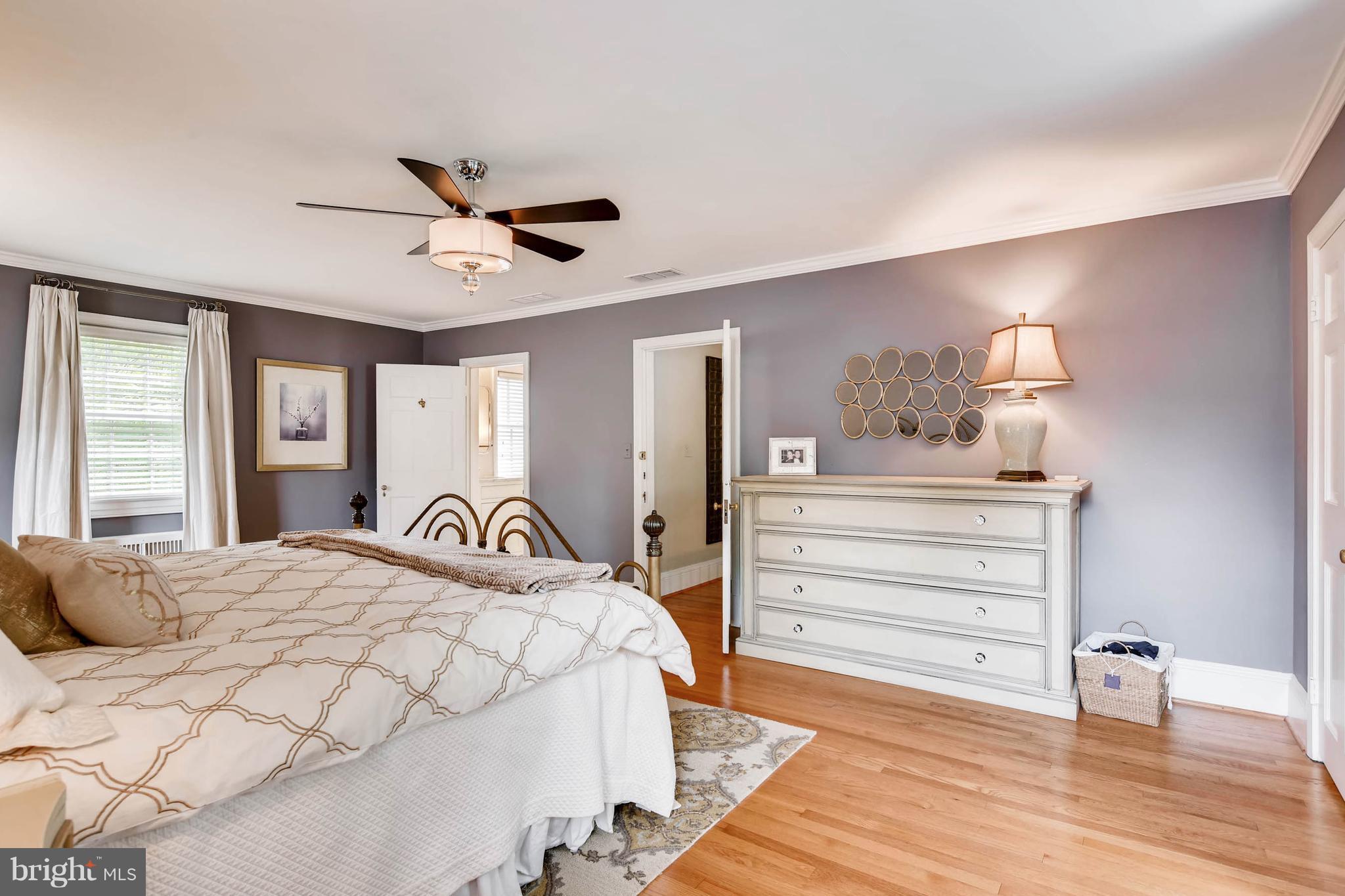 106 Enfield Road Baltimore, MD 21212 - Photo 14 of 27 a bedroom with a bed and wooden floor