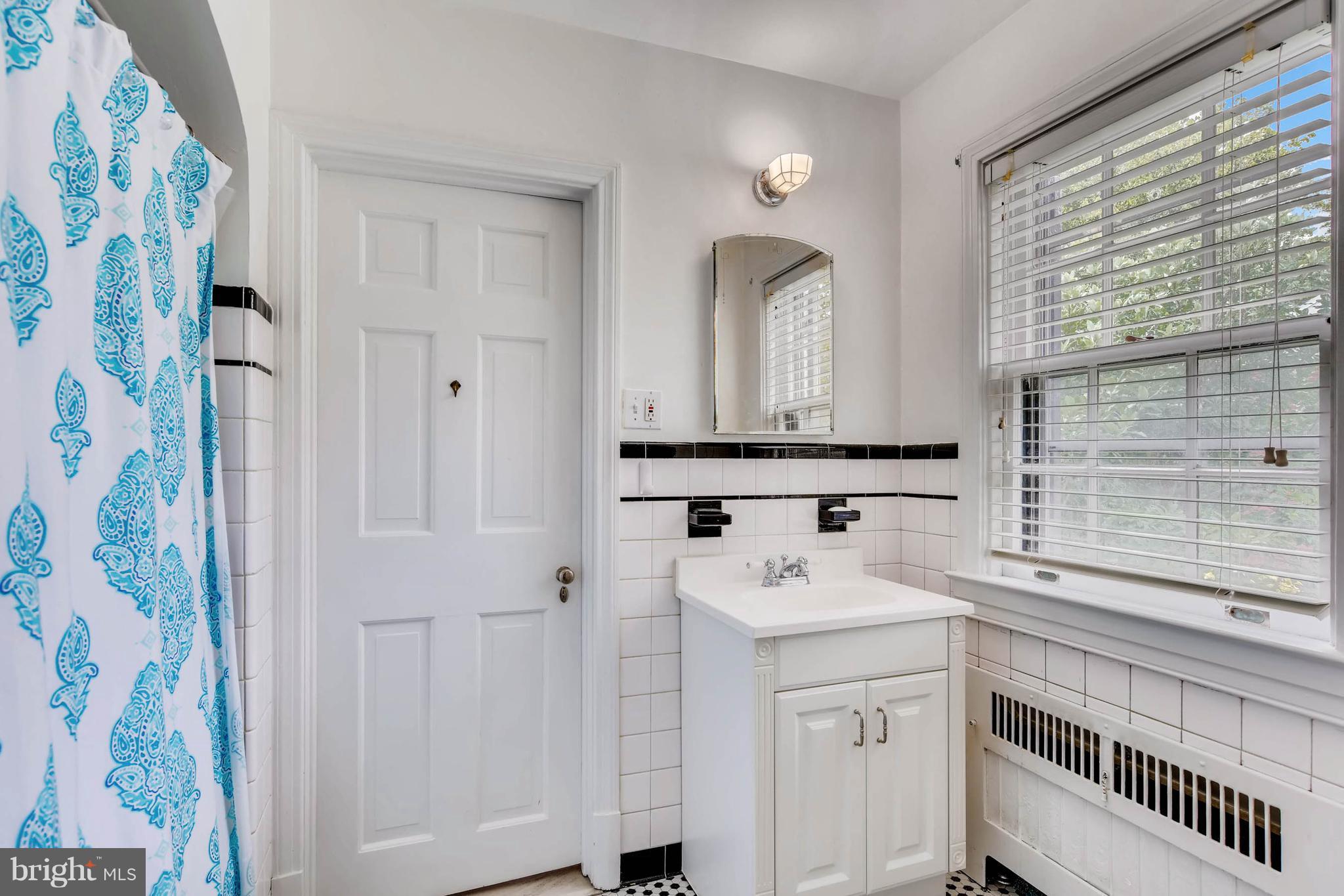 106 Enfield Road Baltimore, MD 21212 - Photo 18 of 27 a bathroom with a sink and a mirror