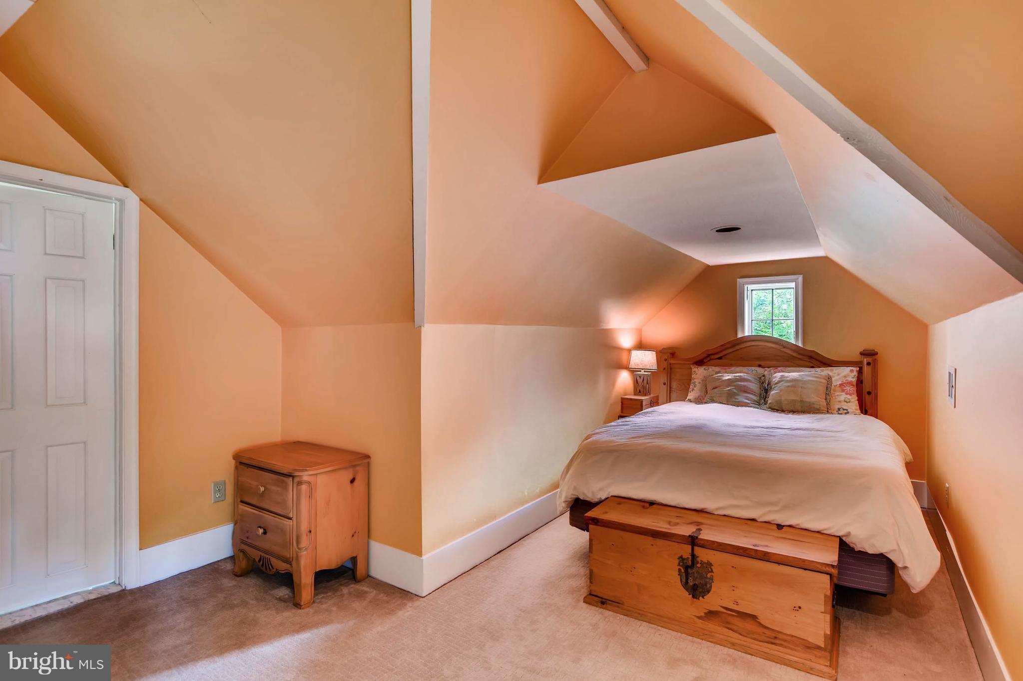 106 Enfield Road Baltimore, MD 21212 - Photo 20 of 27 a room with a bed and a chandelier