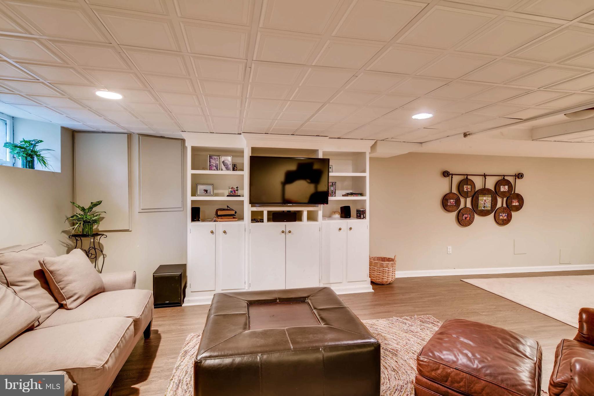 106 Enfield Road Baltimore, MD 21212 - Photo 24 of 27 a living room with furniture and a flat screen tv