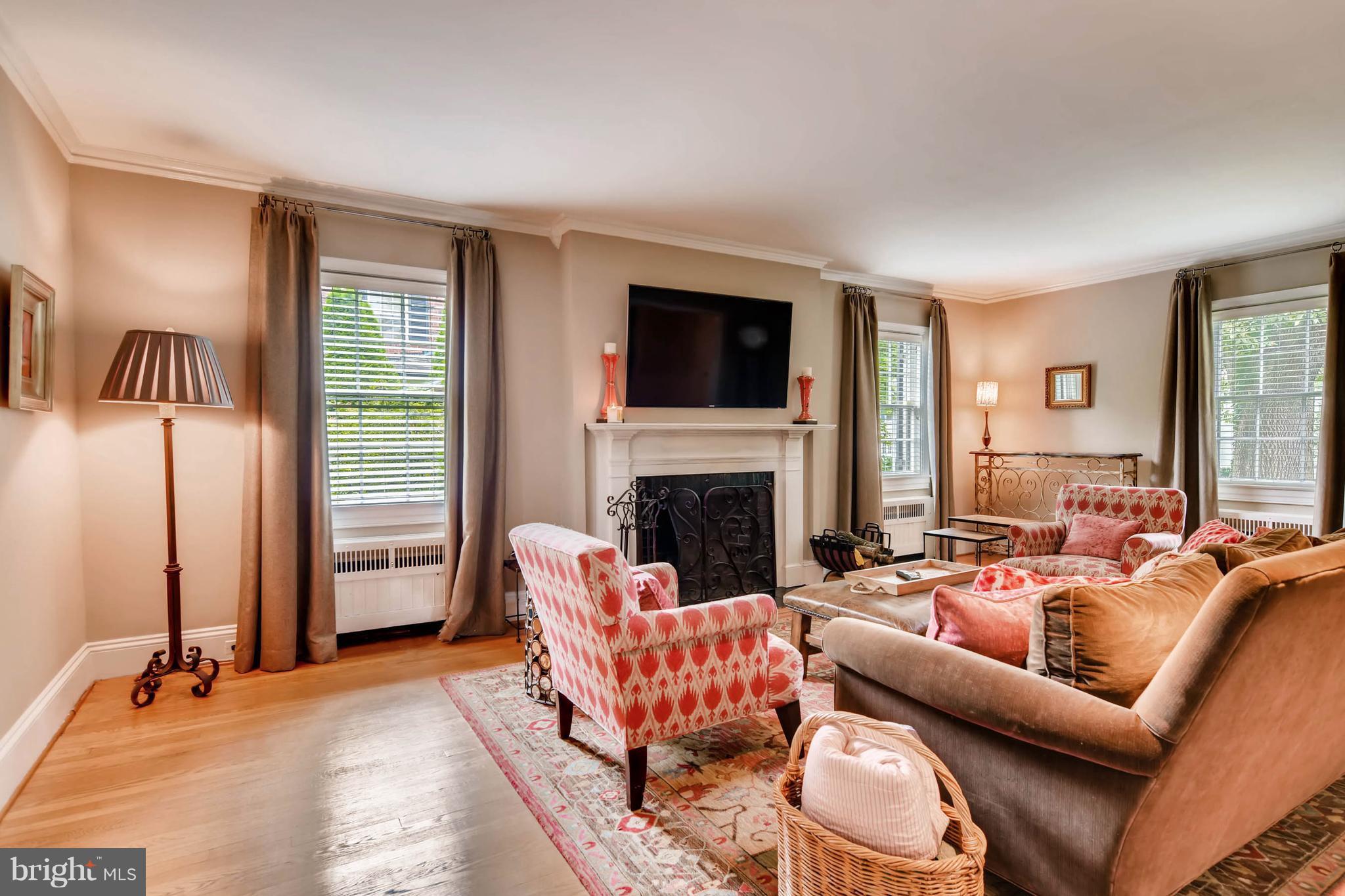 106 Enfield Road Baltimore, MD 21212 - Photo 5 of 27 a living room with furniture fireplace and a flat screen tv