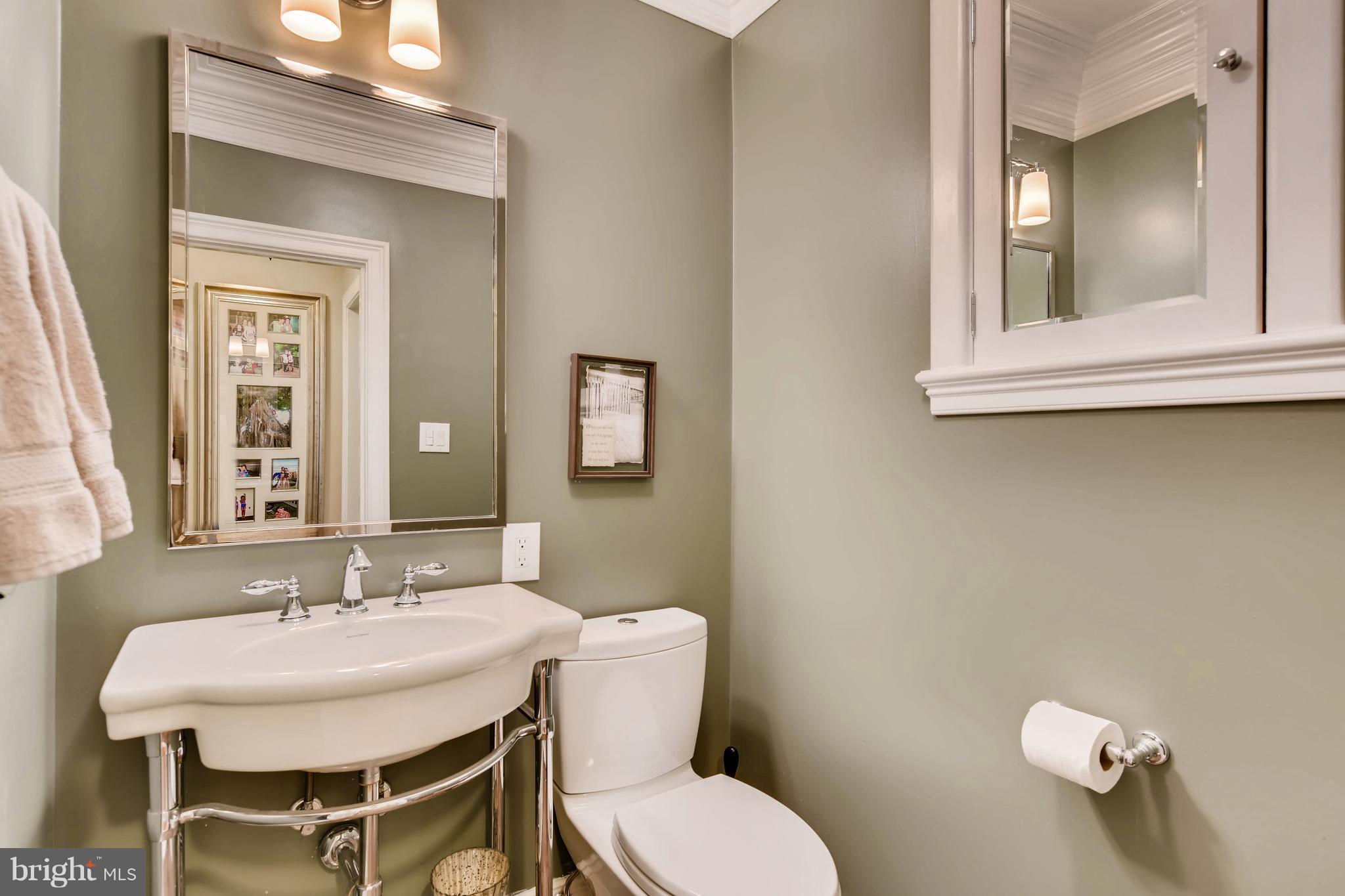 106 Enfield Road Baltimore, MD 21212 - Photo 8 of 27 a bathroom with a toilet a sink and mirror