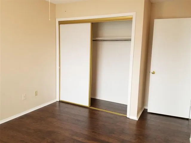 an empty room with wooden floor