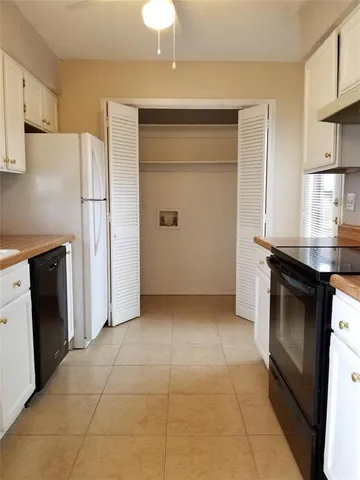 a kitchen with granite countertop a refrigerator and a stove