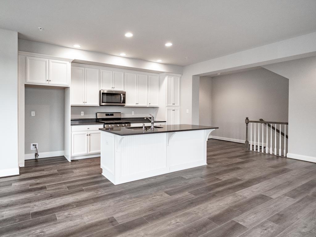 3106 Tulane Way Bridgeville, PA 15017 - Photo 3 of 25 a kitchen with kitchen island a sink and a stove top oven