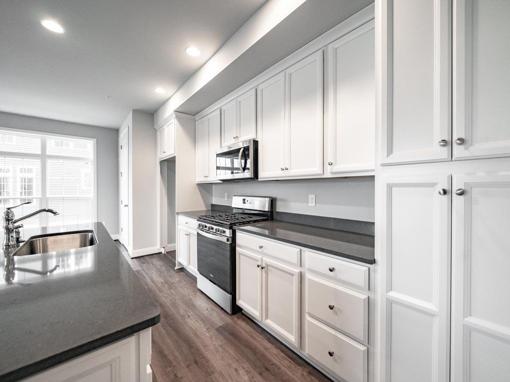 3106 Tulane Way Bridgeville, PA 15017 - Photo 6 of 25 a kitchen with granite countertop a sink a stove and cabinets