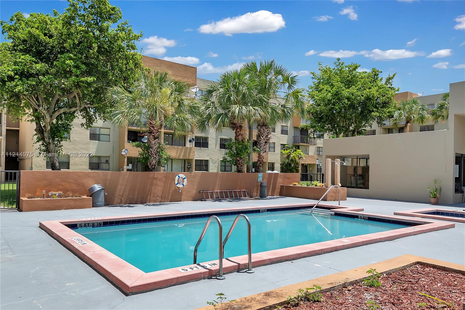 8002 Southwest 149th Avenue, Unit B201 Miami, FL 33193 - Photo 1 of 18 a view of a pool with chairs