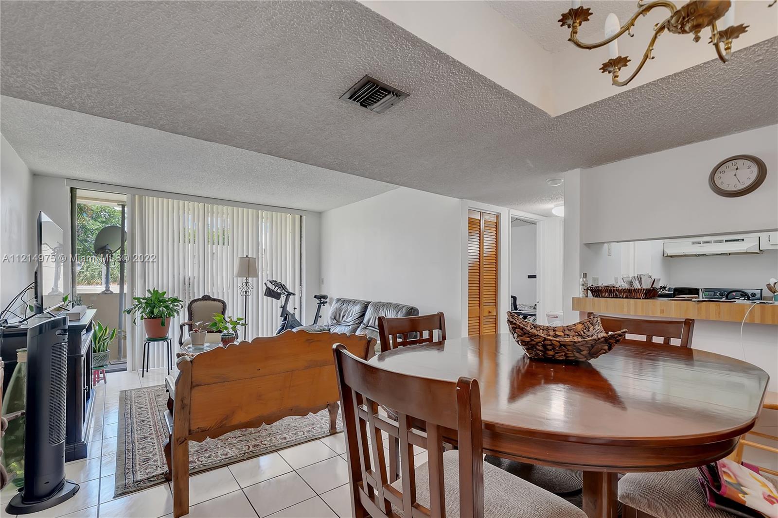 8002 Southwest 149th Avenue, Unit B201 Miami, FL 33193 - Photo 2 of 18 a living room with furniture and a table